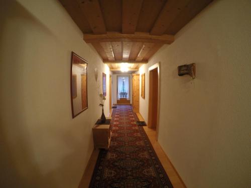 a hallway with a rug on the floor of a house at Haus Weitenstich in Zell am Ziller
