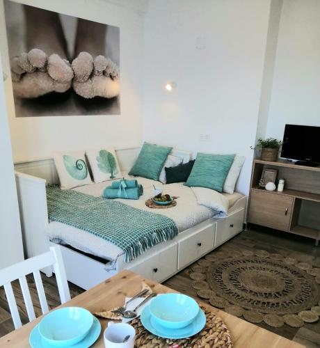 a room with a bed with blue plates on a table at Estudio Pies de Arena in Mijas Costa