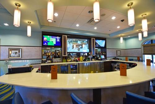 a bar with a large table and a tv at 545 OC - CHAMPIONS GATE in Kissimmee