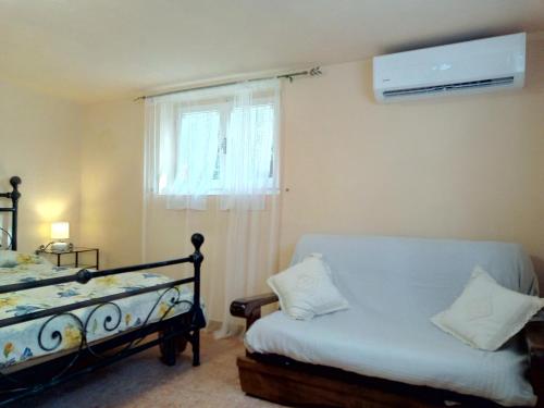 a bedroom with a bed and a window with a fan at Il Giardino di Patrizia in Querceta