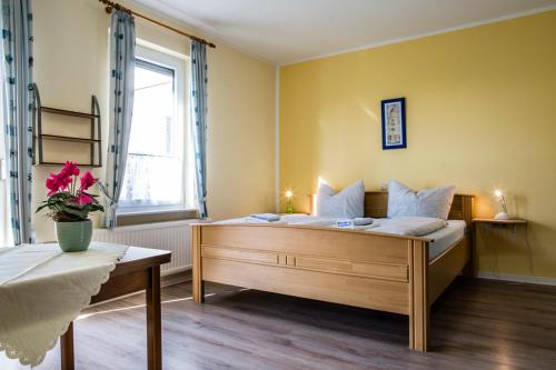 A bed or beds in a room at Logia Hotel garni