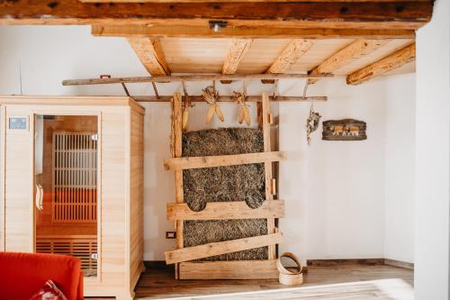 a barn conversion with a wooden ladder in a room at Maso Del Fieno con Sauna Privata e Vista Unica in Sant'Orsola Terme