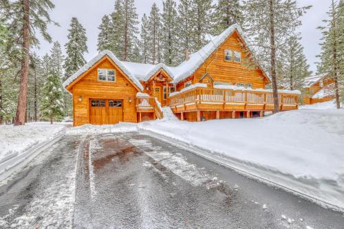 a log cabin in the snow with a driveway at Snowpeak Chalet in Tahoe Donner in Truckee