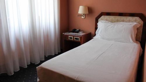 Ένα ή περισσότερα κρεβάτια σε δωμάτιο στο Hotel Bristol