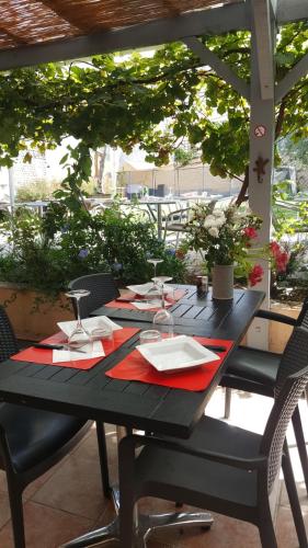 a black table with red napkins and glasses on it at HOTEL DE FRANCE in Maubourguet