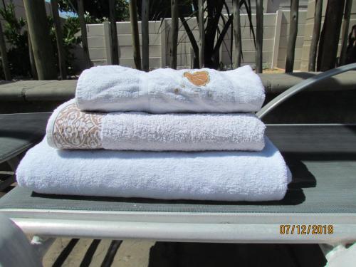 a stack of towels sitting on top of a table at Princess Holiday Home in Cape Town