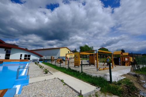 a playground with a slide and a pool at Lipno-Frymburk Wellnes APT D 103 in Frymburk