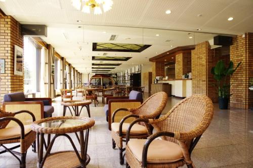 a restaurant with chairs and tables in a building at Case House Hokkaido / Vacation STAY 61607 in Higashikawa