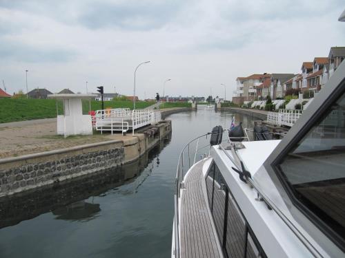 a boat is docked next to a canal with buildings at Hotel Brasserie Smits in Wemeldinge