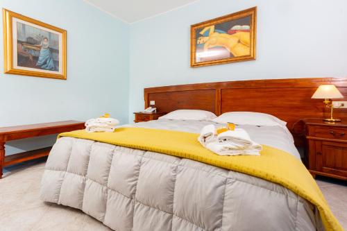 una camera da letto con un letto e asciugamani di Hotel Marini a Sassari
