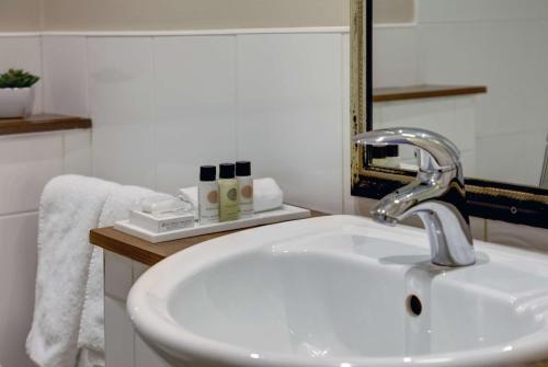a bathroom with a white sink and a mirror at Crown & Mitre Hotel in Carlisle