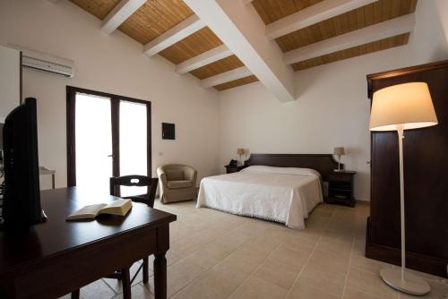 En eller flere senger på et rom på La Dimora di Spartivento - BW Signature Collection