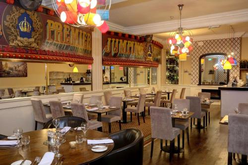 a restaurant with tables and chairs and a bar at Crown & Mitre Hotel in Carlisle