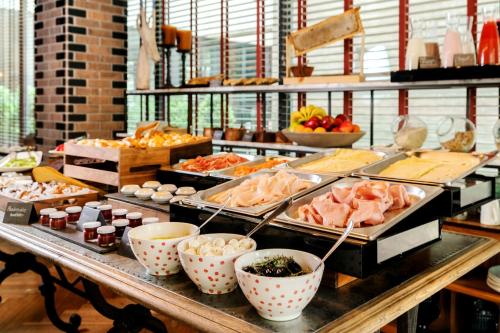 a buffet with many different types of food on a table at Hyatt Centric Las Condes Santiago in Santiago