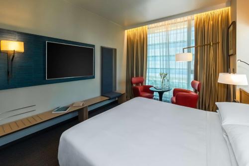 a hotel room with a bed and a flat screen tv at Hyatt Centric Las Condes Santiago in Santiago