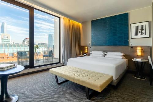 a bedroom with a large bed and a large window at Hyatt Centric Las Condes Santiago in Santiago