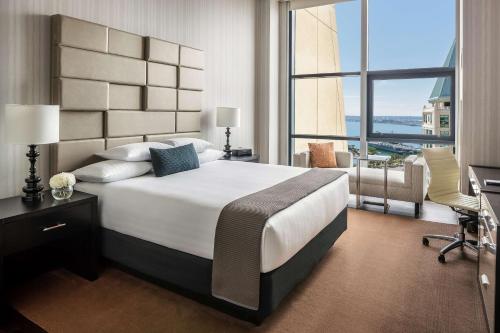 a bedroom with a large bed and a large window at Manchester Grand Hyatt San Diego in San Diego