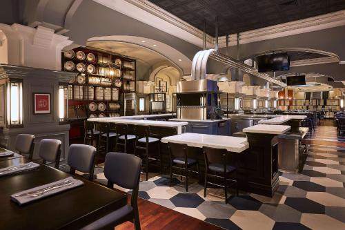 a large kitchen with tables and chairs in a restaurant at Manchester Grand Hyatt San Diego in San Diego