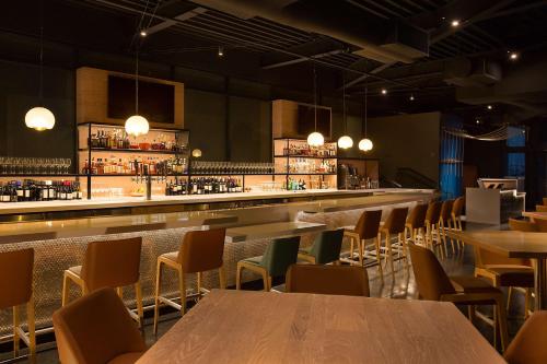 a restaurant with tables and chairs and a bar at Manchester Grand Hyatt San Diego in San Diego