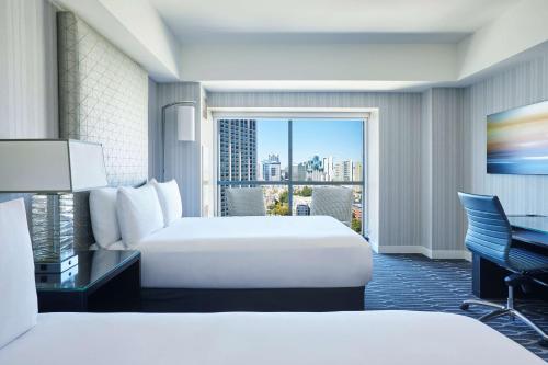 a hotel room with two beds and a balcony at Manchester Grand Hyatt San Diego in San Diego