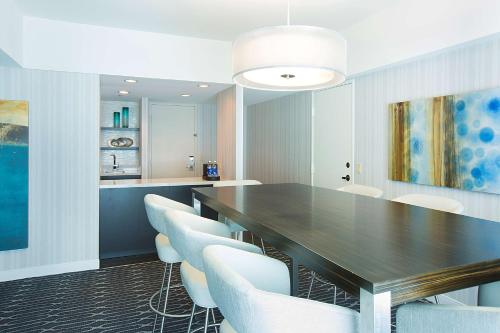 a dining room with a table and white chairs at Manchester Grand Hyatt San Diego in San Diego