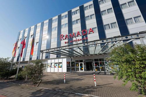 a building with a sign on the front of it at Ramada by Wyndham Hannover in Hannover