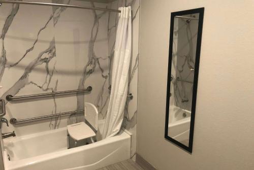 a bathroom with a toilet and a shower curtain at Super 8 by Wyndham Spring/North Houston in Spring
