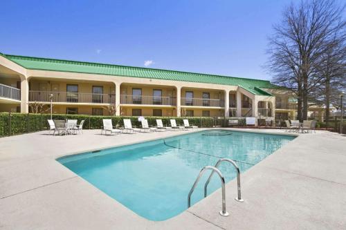 a swimming pool in front of a hotel at Howard Johnson by Wyndham Greensboro Near the Coliseum in Greensboro