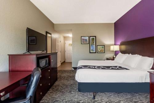 a hotel room with a bed and a desk at La Quinta by Wyndham Port Orange / Daytona in Port Orange