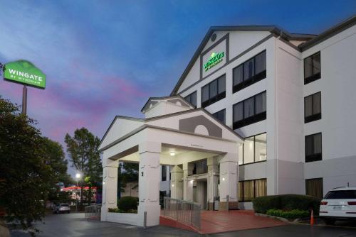 a hotel building with a sign in front of it at Wingate by Wyndham Memphis East in Memphis