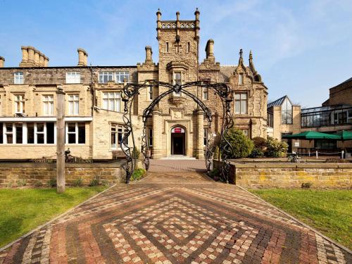 an entrance to an old stone building with an archway at Mercure Bradford, Bankfield Hotel in Bradford