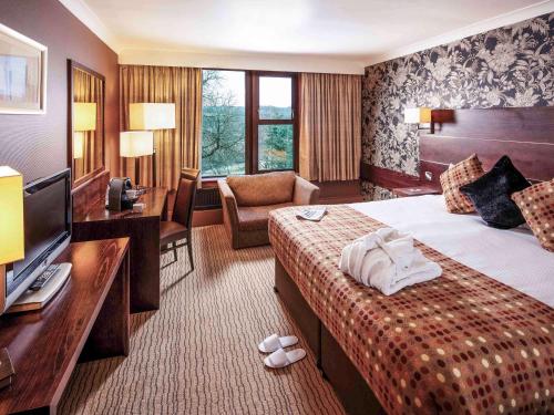 a hotel room with a bed and a television at Mercure Bradford, Bankfield Hotel in Bradford