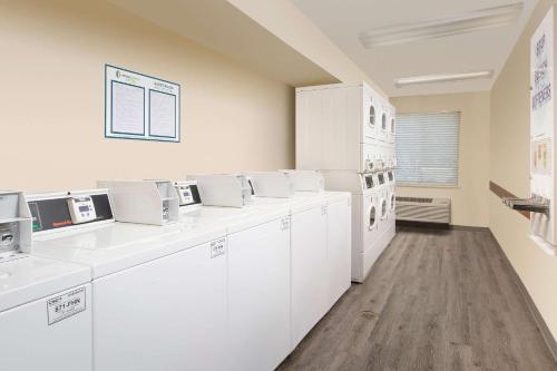 um laboratório com balcões e electrodomésticos brancos numa sala em Woodspring Suites Huntsville/ Madison em Madison