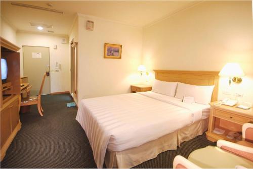 Postel nebo postele na pokoji v ubytování Cambridge Hotel - Yung Kang