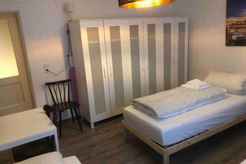 a bedroom with a bed and a table and a chair at Obergeschoss in Alzenau in Unterfranken