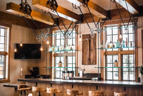 a bar in a restaurant with chairs and windows at Hyatt Vacation Club at The Ranahan in Breckenridge