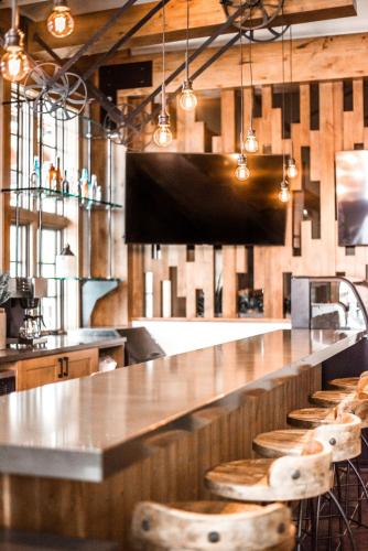 a kitchen with a bar with wooden stools at Hyatt Vacation Club at The Ranahan in Breckenridge