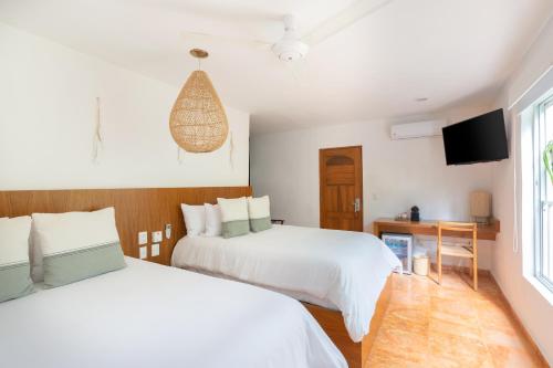 Cama o camas de una habitación en Mereva Tulum