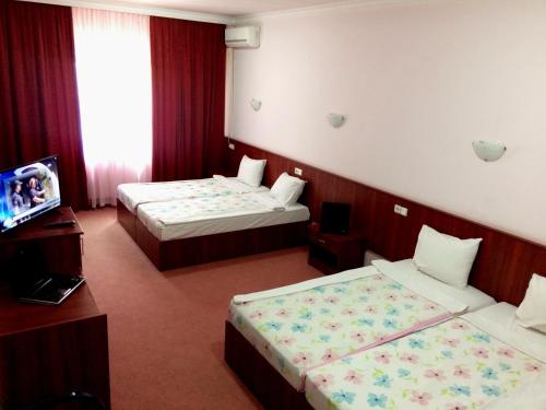 En eller flere senge i et værelse på Hotel Oxa doo