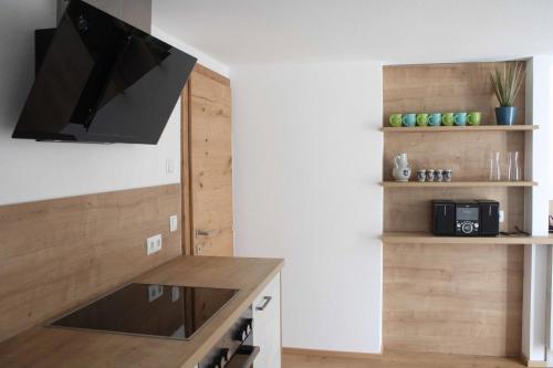 a living room with a flat screen tv on a wall at Das K - dei "Hoamatl" im Ötztal in Oetz