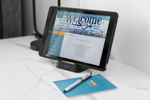 a computer monitor sitting on a desk with a pen at Crystalbrook Bailey in Cairns