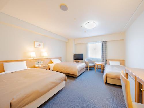 A bed or beds in a room at Hotel Grand Terrace Obihiro