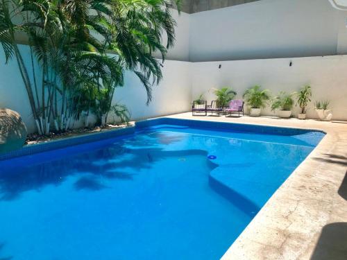 a swimming pool with blue water in a house at Acapulco suites Y condominio Mediterrane in Acapulco