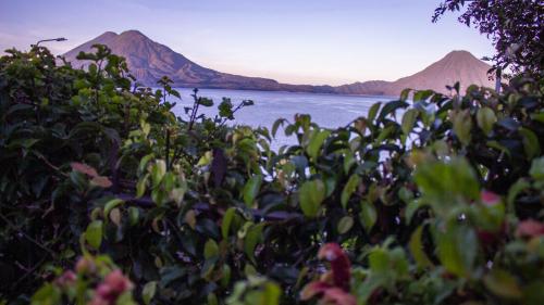 a view of a body of water with mountains in the background at Hotel Posada de Don Rodrigo Panajachel in Panajachel