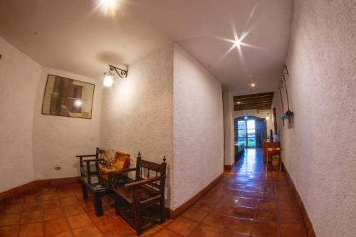 a hallway with white walls and a tile floor at Hotel Posada de Don Rodrigo Panajachel in Panajachel