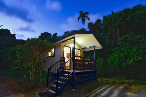 a tiny house with a staircase leading up to it at Thornton Beach Bungalows Daintree in Cape Tribulation
