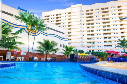 a swimming pool in front of a hotel at Golden Dolphin Caldas Novas in Caldas Novas
