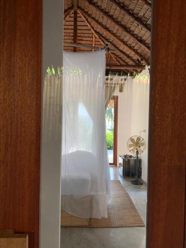 a bed with a white canopy in a room at Inhale @ Hill in Koh Mook