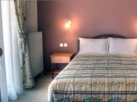 Postel nebo postele na pokoji v ubytování Guesthouse Evi Maria