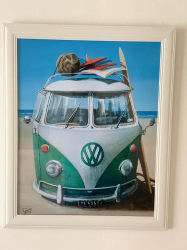 a painting of a vw van with surfboards on top at Academy Motor Inn in Tauranga